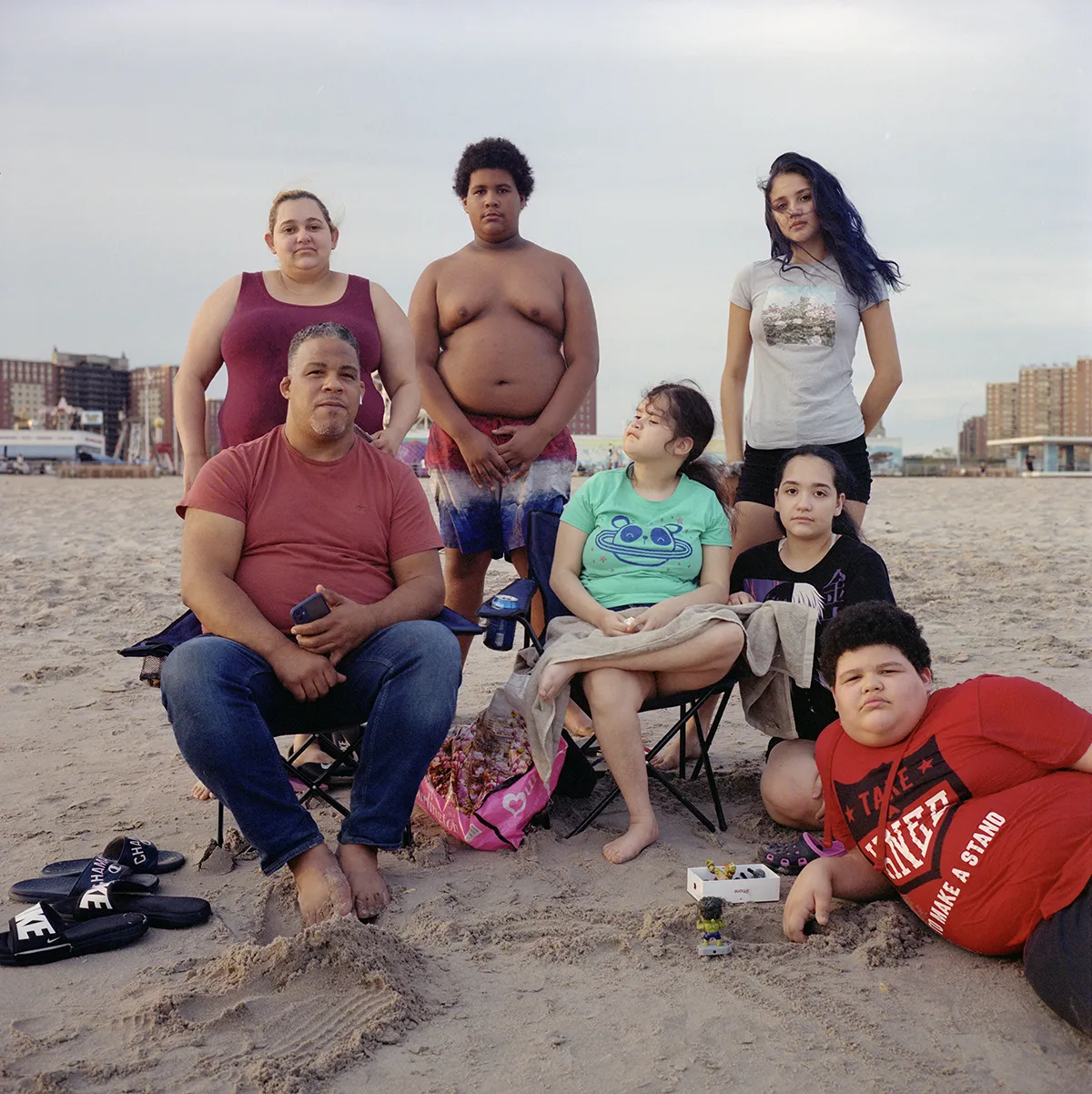 A family sitting for a portrait on the beach