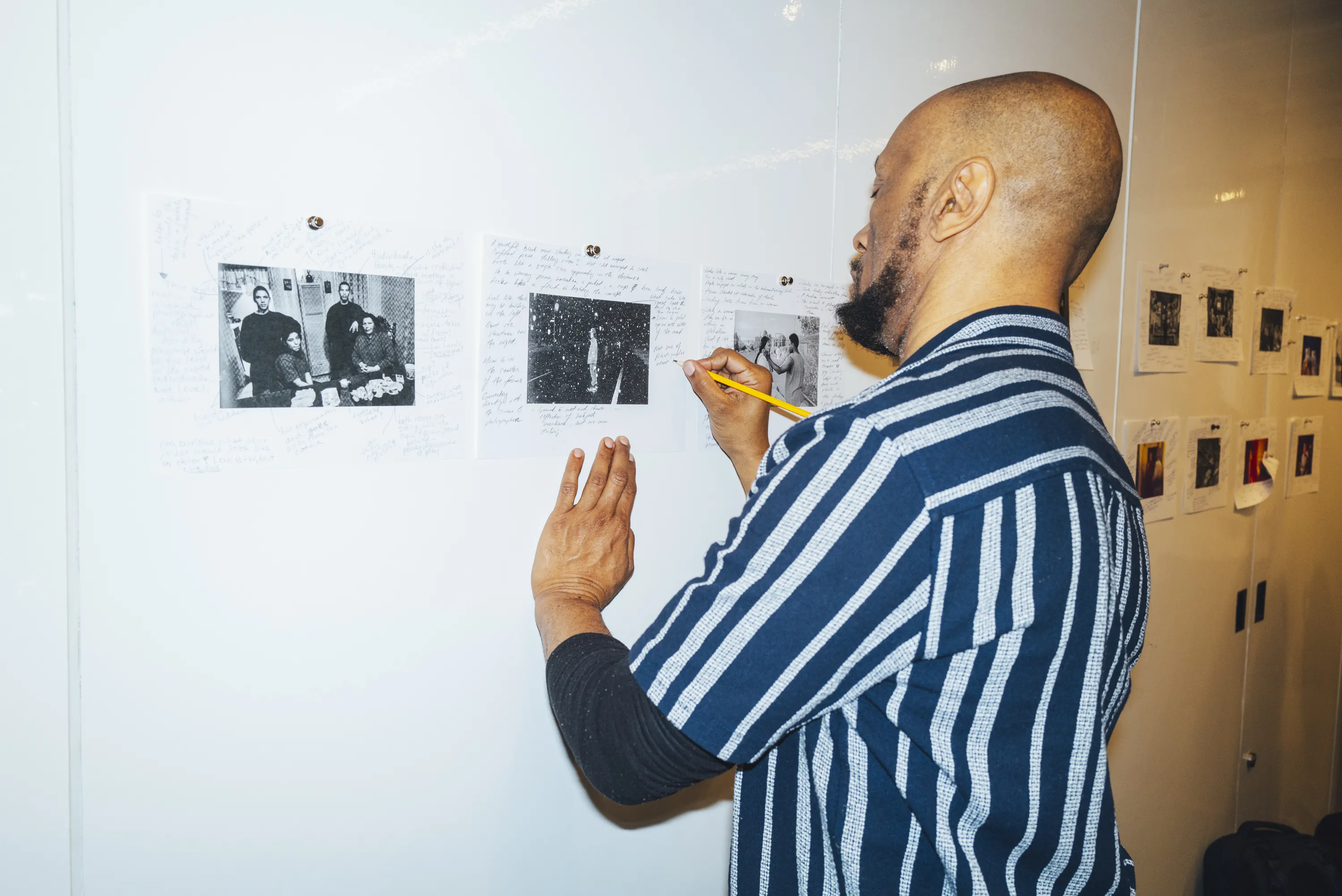Student taking notes on images on a white board